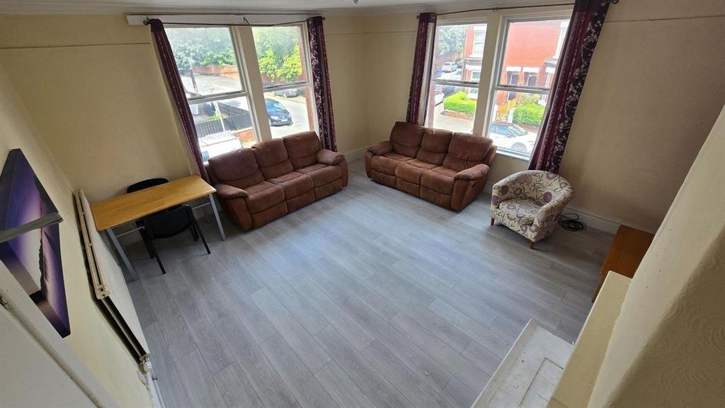 Bright, modern living room with large bay windo...
