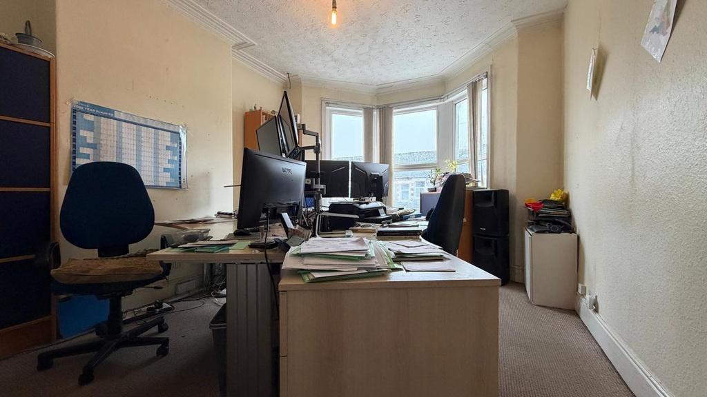 Bright, practical communal workspace with multi...