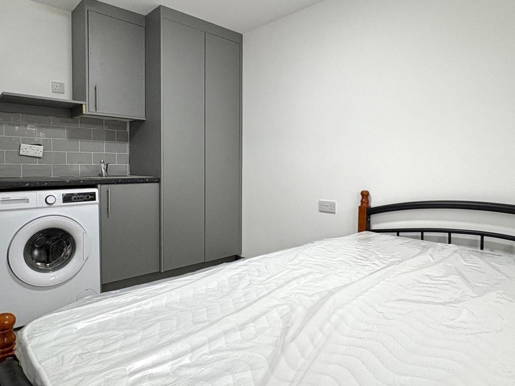 Neat bedroom with a comfortable double bed, bui...