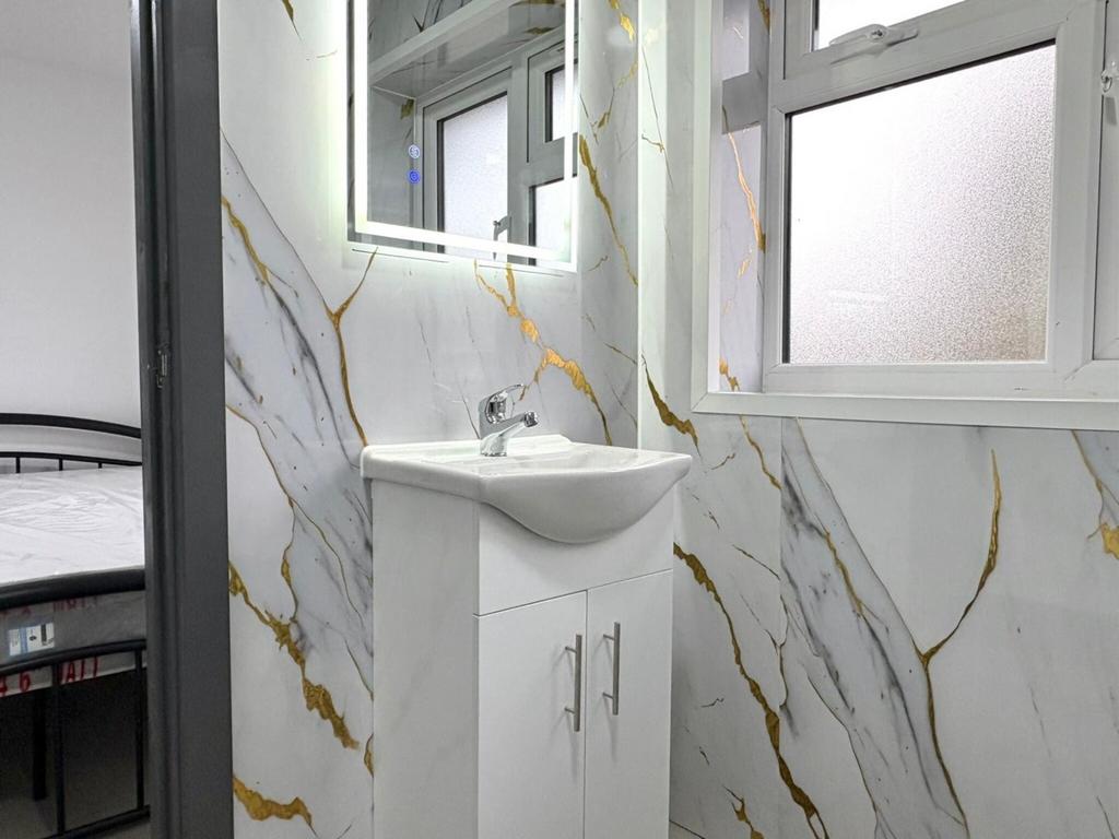 Bright, modern bathroom with sleek white vanity...