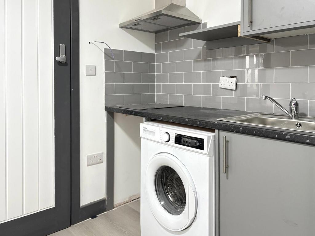 Compact, modern kitchenette featuring integrate...