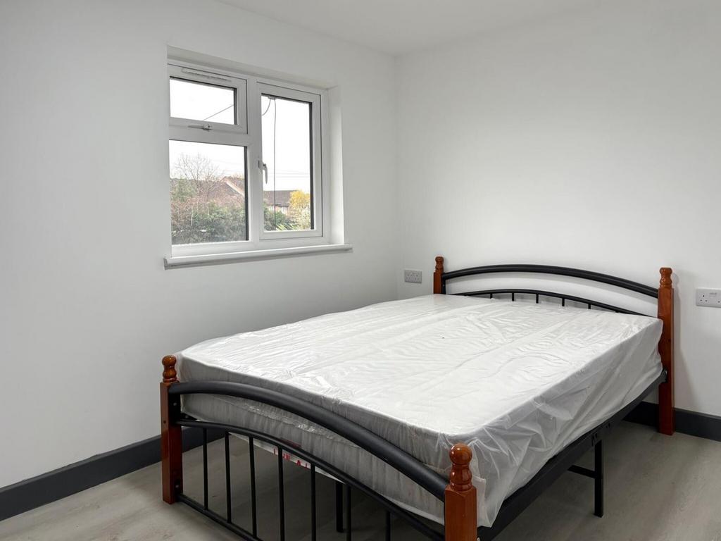 Bright, simply furnished double bedroom with a ...
