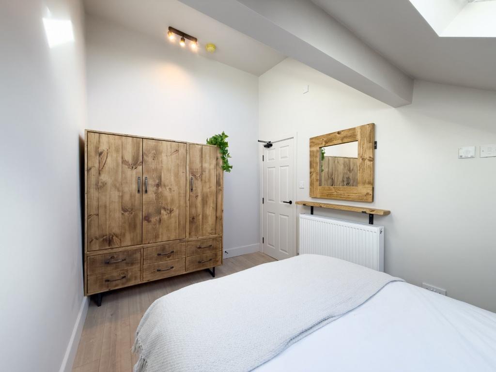 Bright, neatly presented bedroom with a comfort...