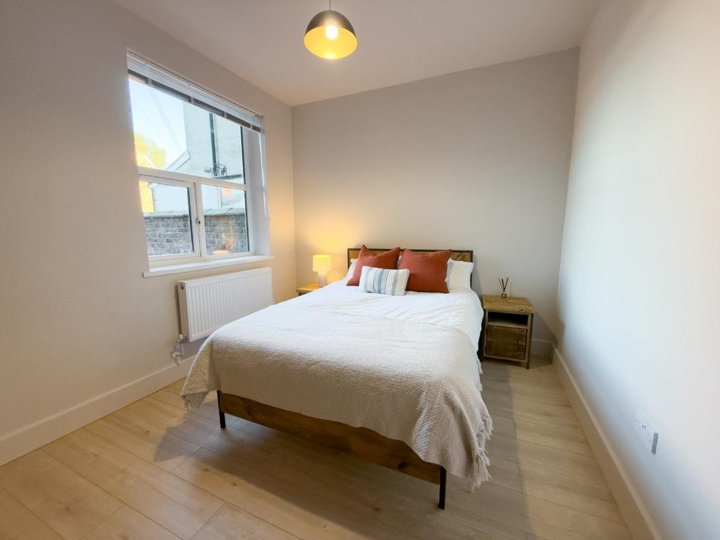 Bright, neatly presented bedroom with a double ...