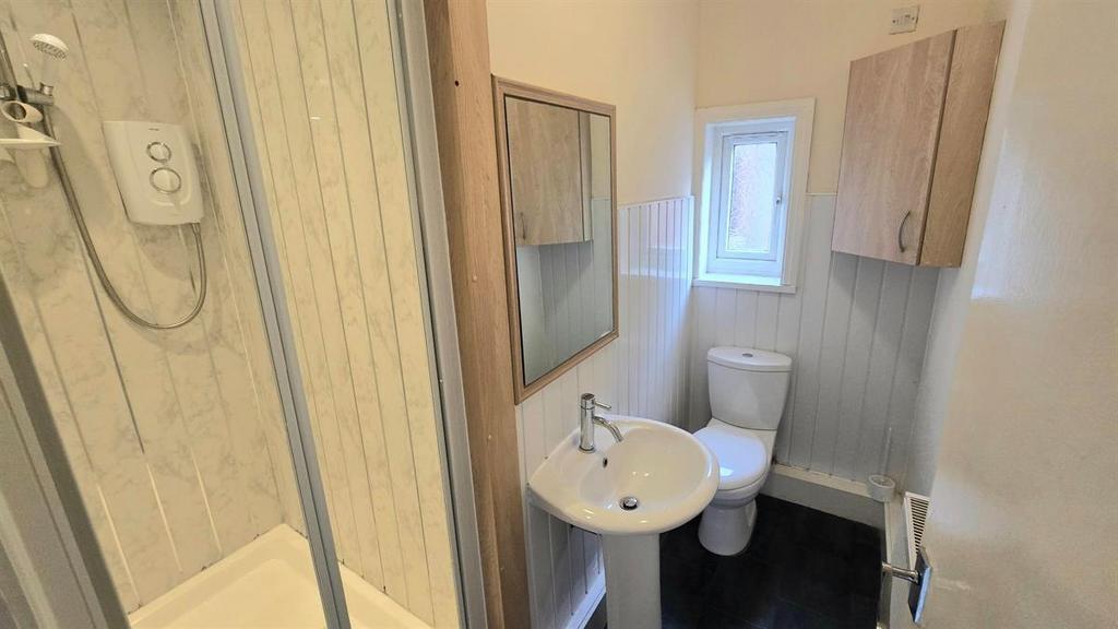 Bright, tidy bathroom with a corner shower, bas...