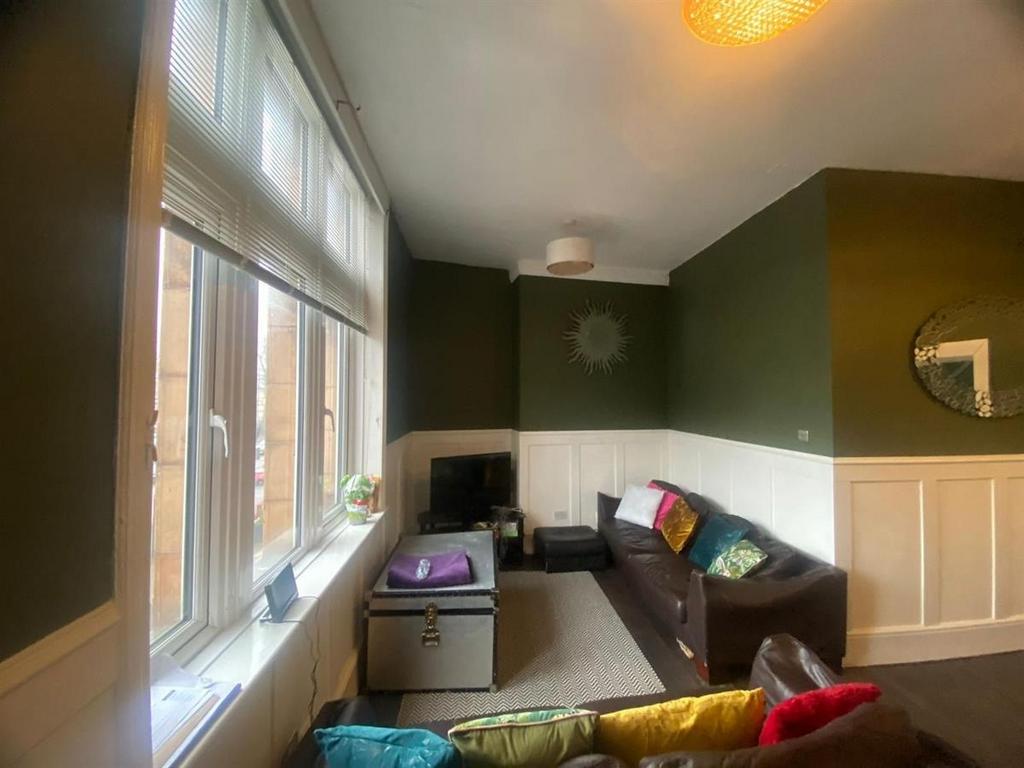 Bright, stylish living room with a large corner...