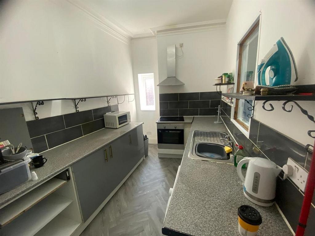 Bright galley-style kitchen with modern fitted ...