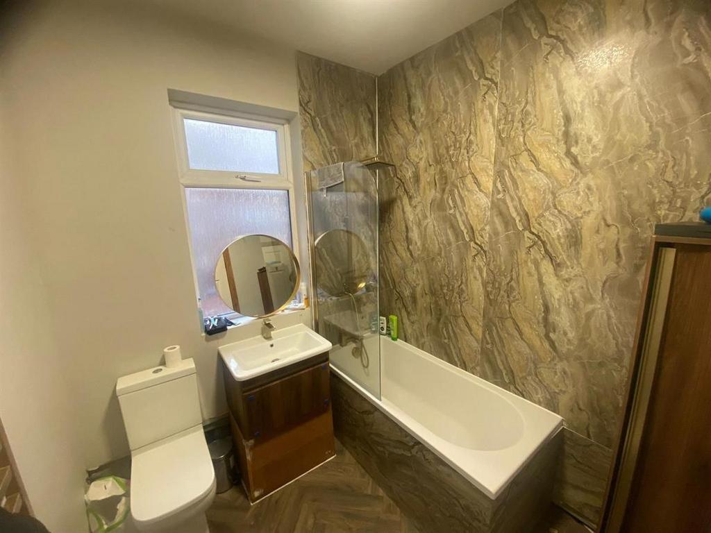 Contemporary bathroom with a bathtub and overhe...