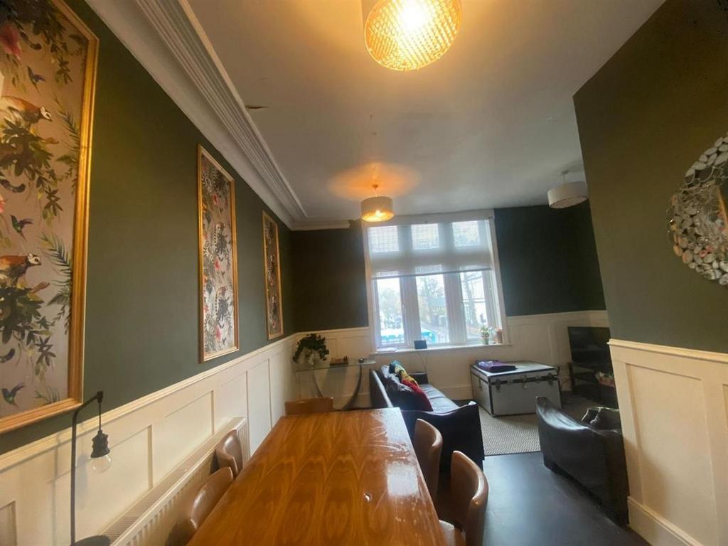 Bright, stylish living room with large bay wind...