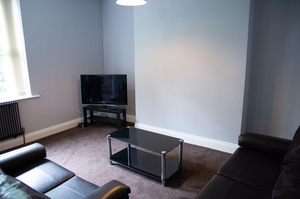 A modern and tidy living room featuring comfort...