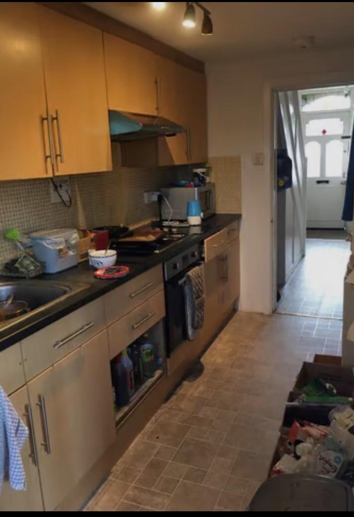 A spacious kitchen with ample storage and natur...