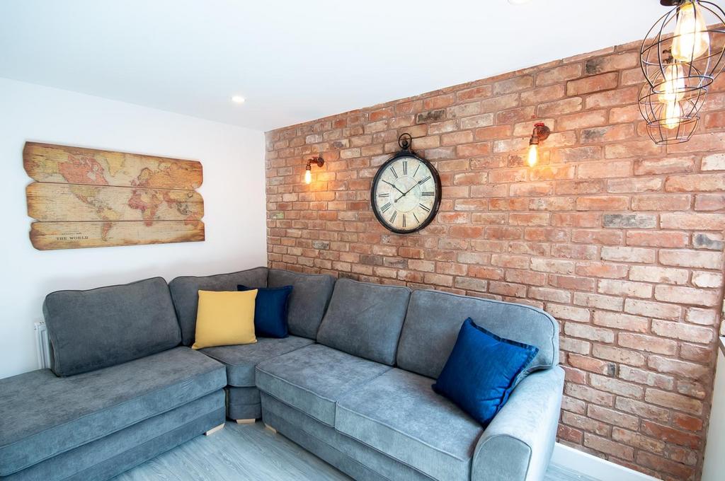 A stylish living room featuring a spacious grey...