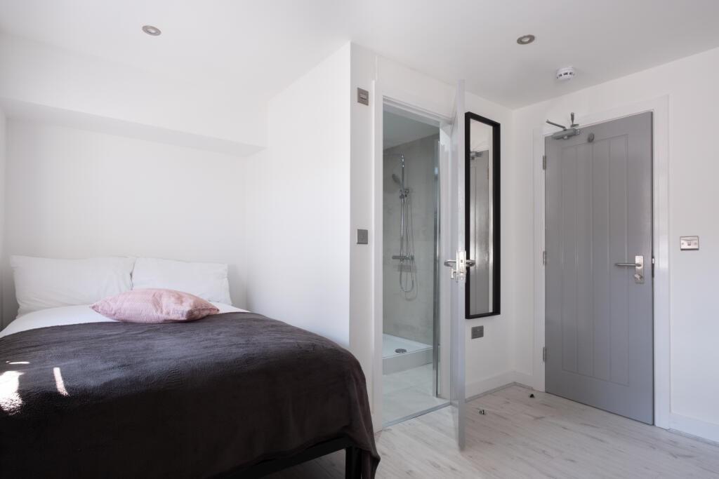 Bright and modern double bedroom featuring a co...