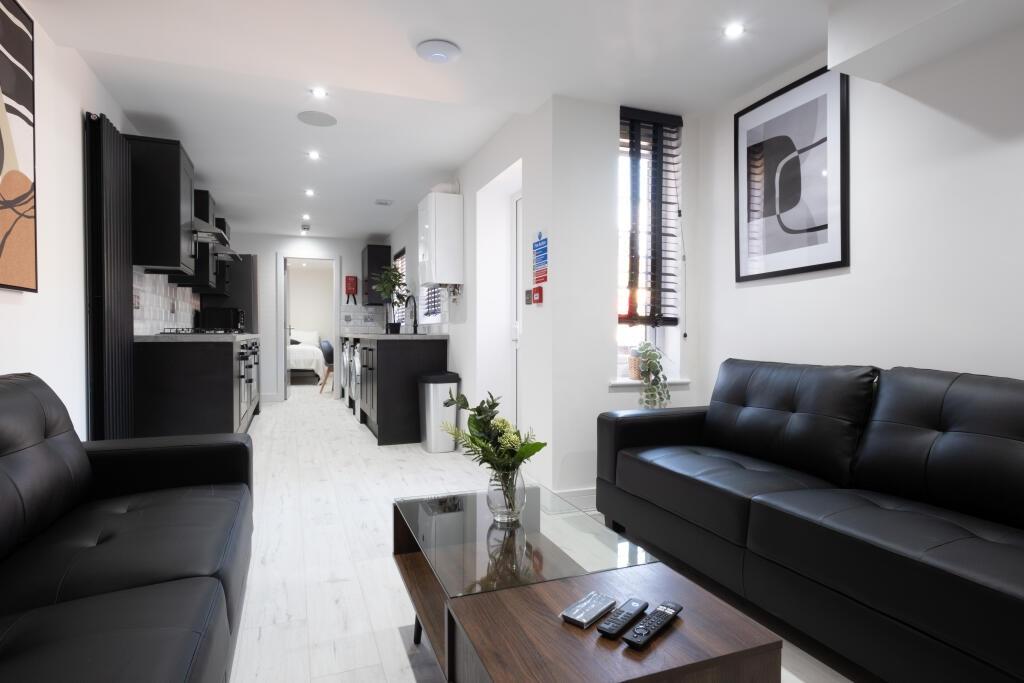 A modern and stylish living room featuring slee...