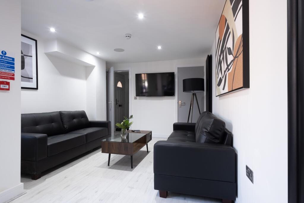 Contemporary living room featuring sleek black ...