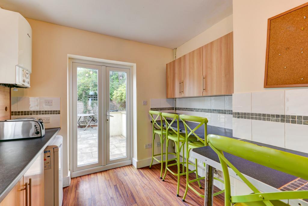 Bright and modern kitchen featuring natural lig...