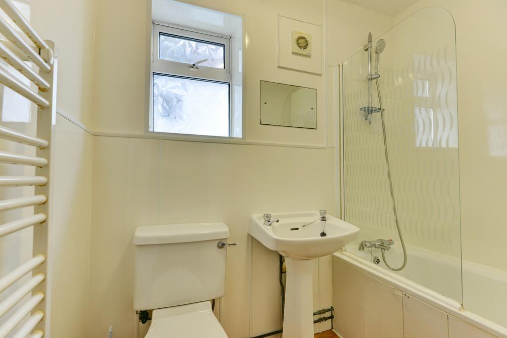 A clean and bright bathroom featuring a standar...
