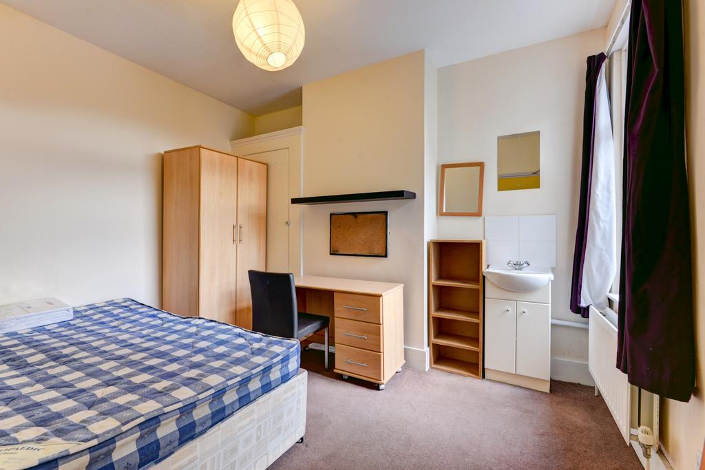 A well-maintained bedroom featuring a double be...