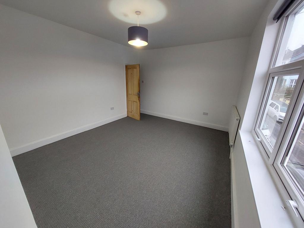 Bright, freshly painted double bedroom with a l...