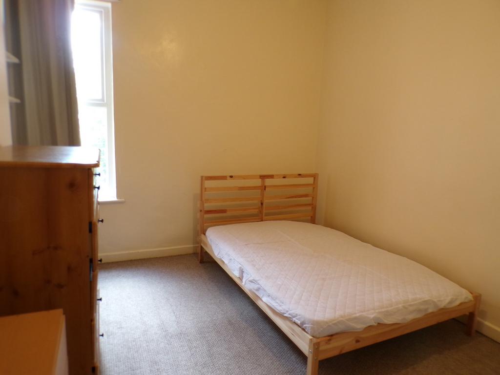 A cozy double bedroom with ample natural light,...