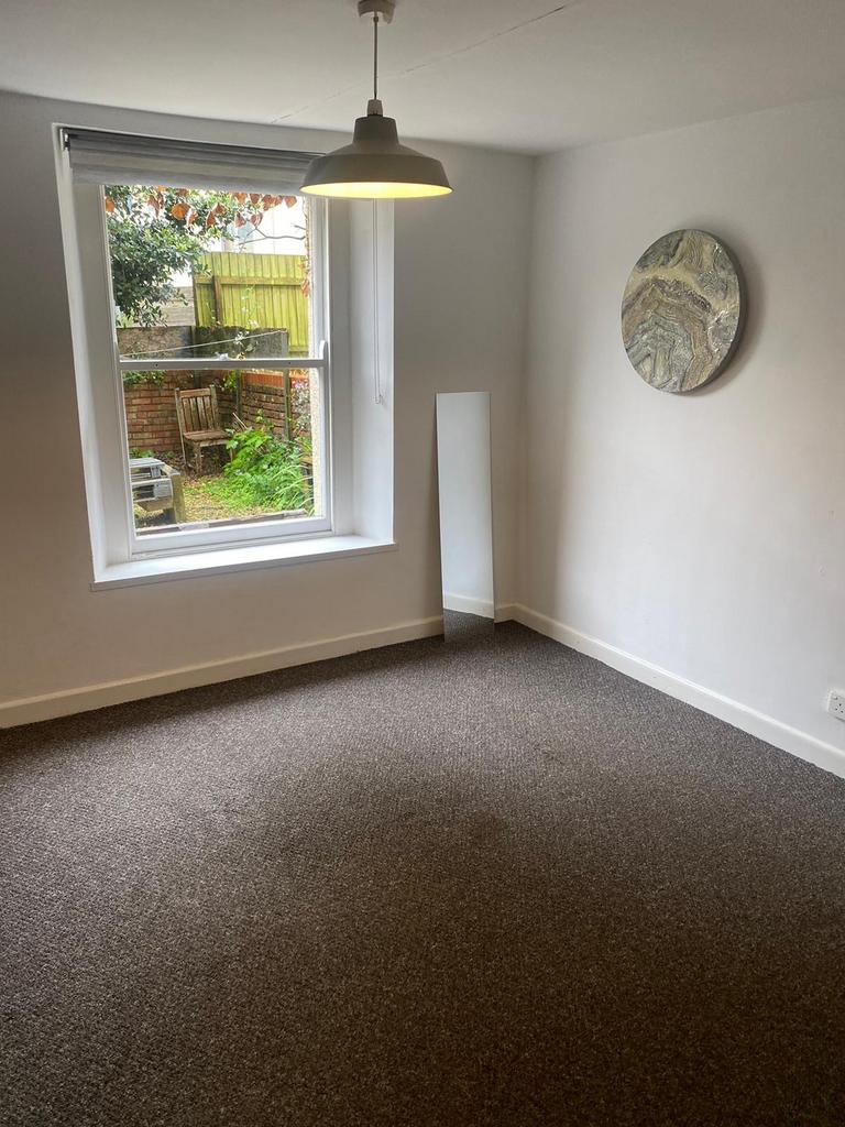 Bright and welcoming living room with a large w...