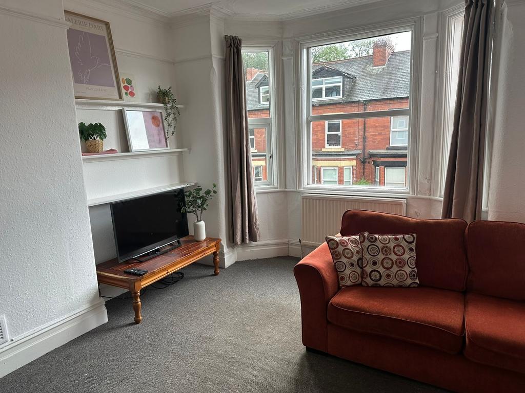 Bright and welcoming living room with large bay...