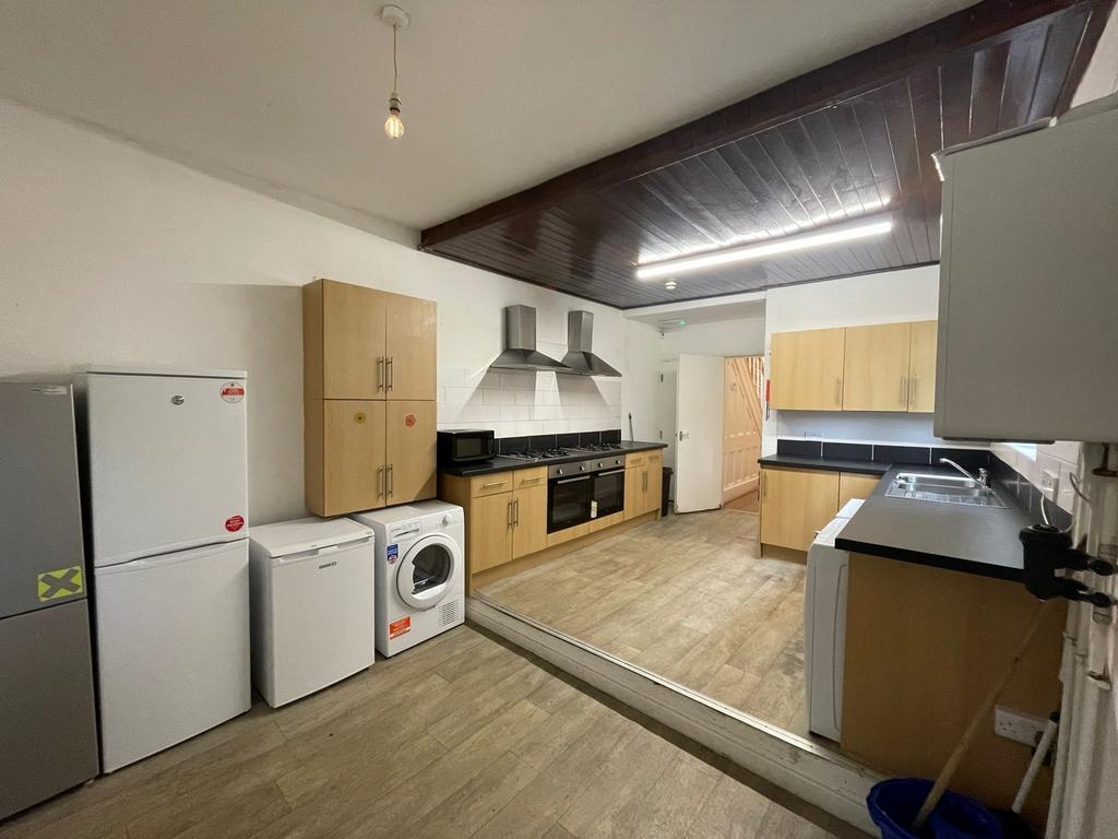 A spacious and modern kitchen equipped with ess...