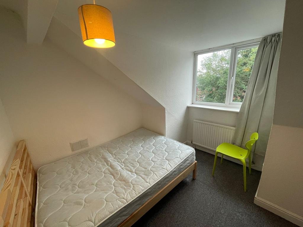 A bright and cozy double bedroom featuring a la...