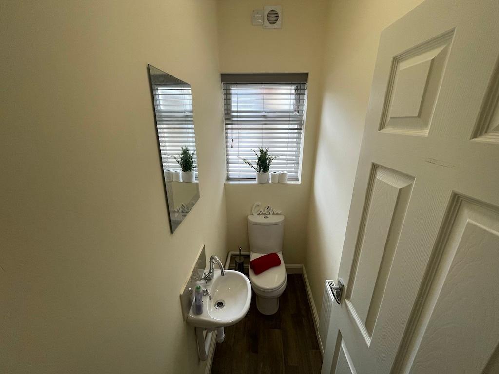 Neat, well-kept WC with a compact basin, contem...