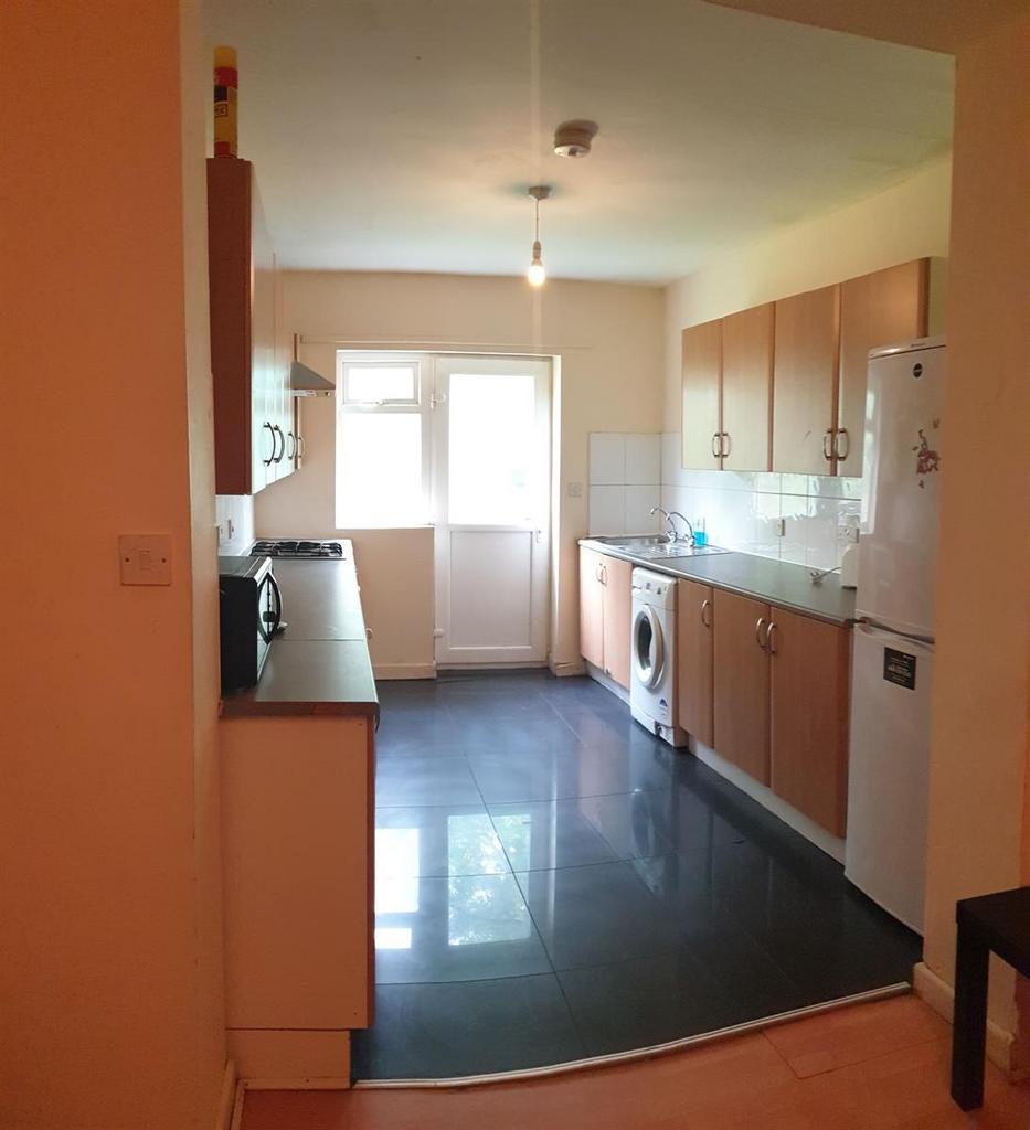 Bright galley kitchen with modern fitted units,...