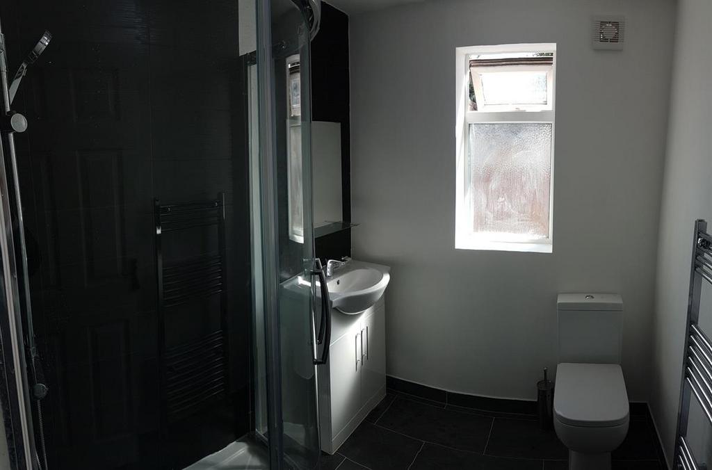 Modern bathroom with a glass shower enclosure, ...