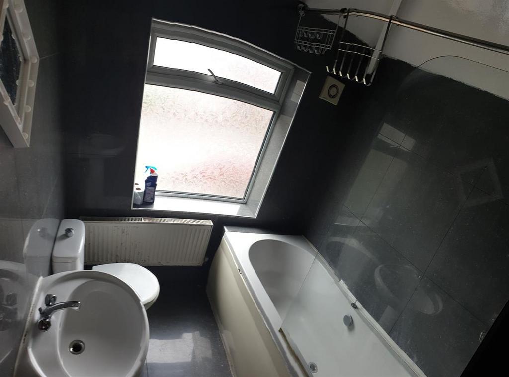 Modern bathroom with a white bathtub, sink and ...