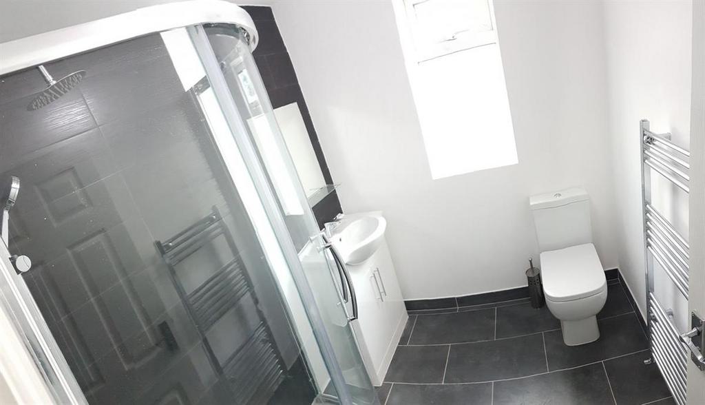 Modern bathroom with a corner shower enclosure,...