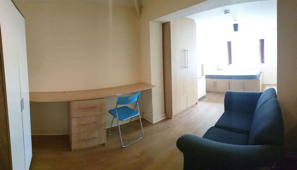 Bright furnished living area with a comfortable...