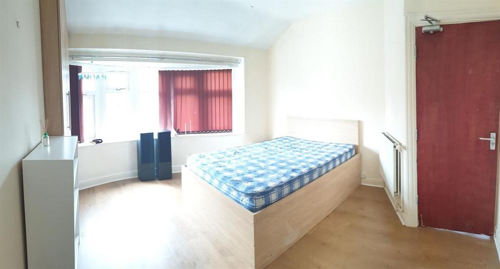 Bright, simply furnished bedroom with a raised ...