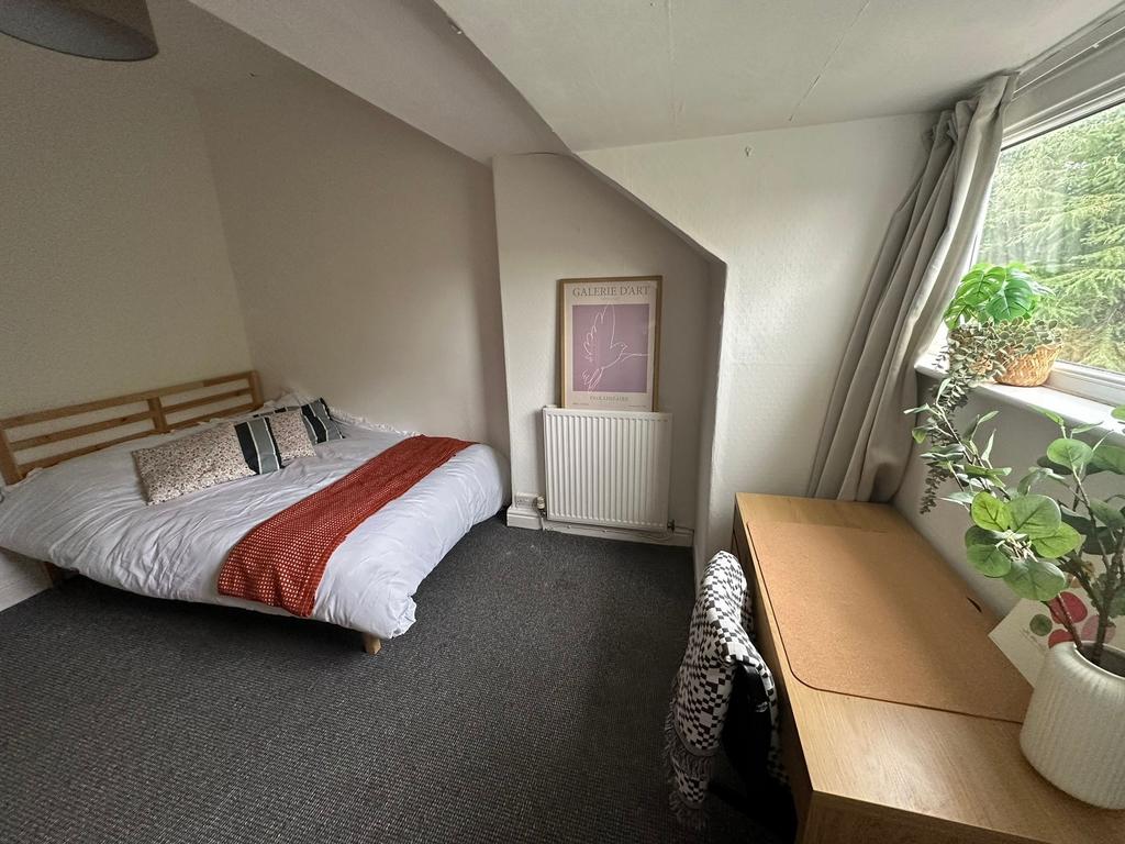A spacious and inviting bedroom with a comforta...