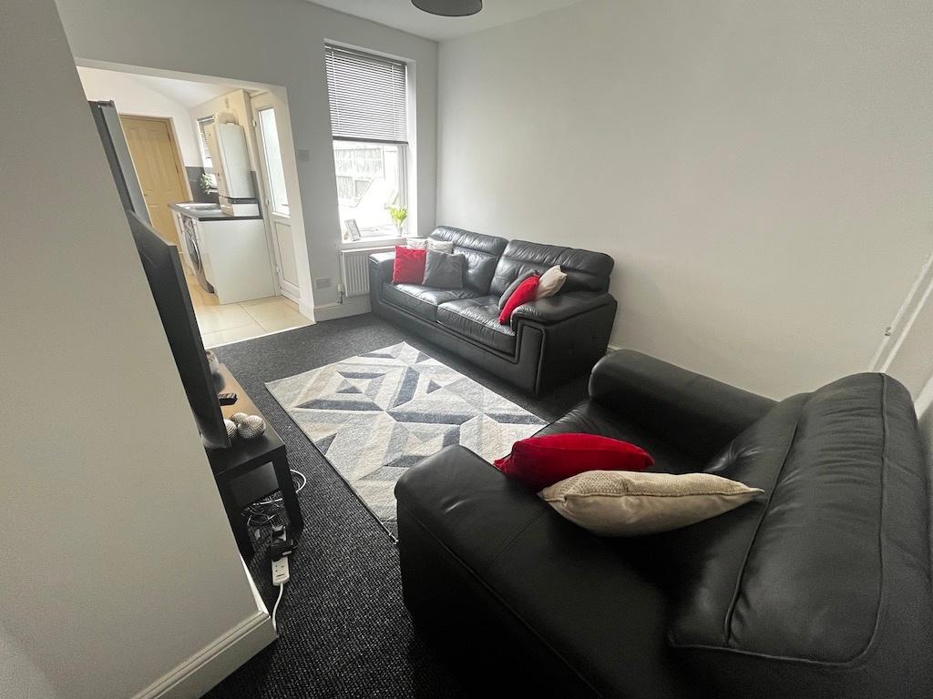 Bright, simply styled living room with two blac...