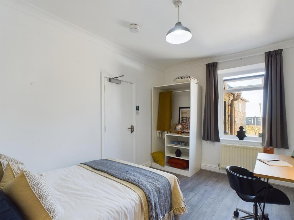 A bright and inviting double bedroom featuring ...