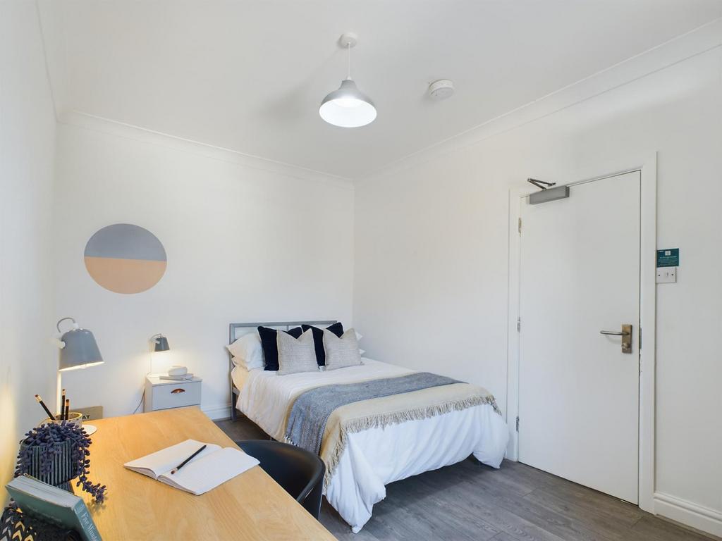 A stylish and inviting double bedroom with ampl...