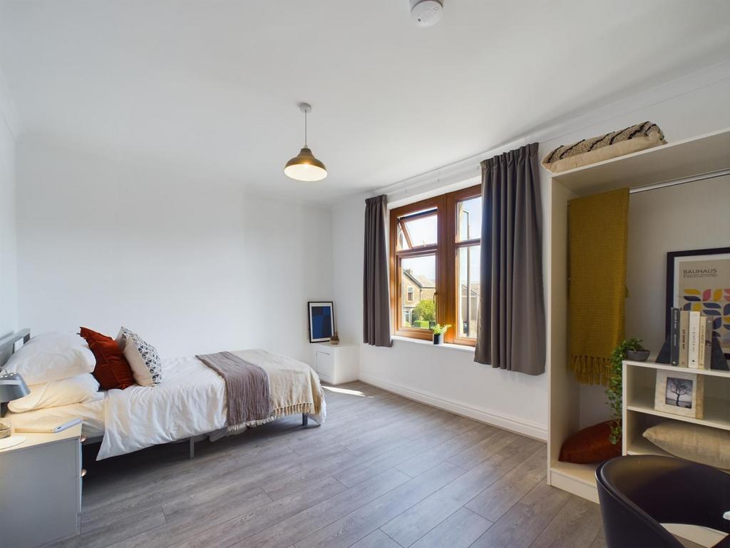 A bright and spacious double bedroom featuring ...