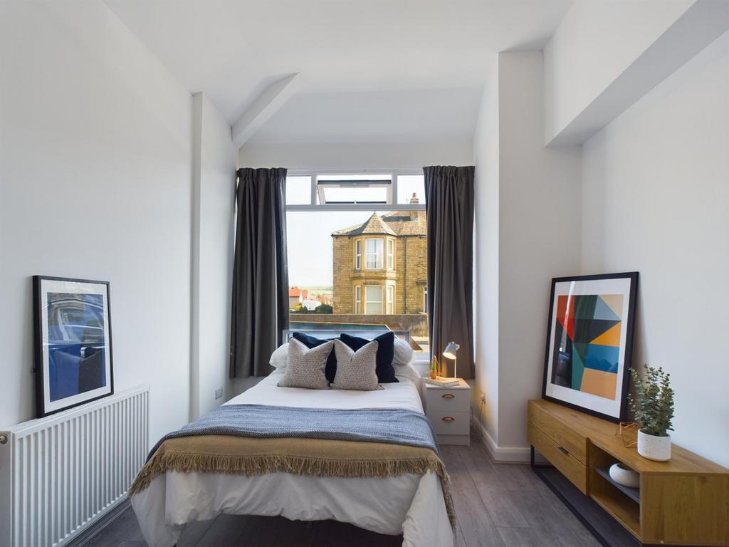 A bright and inviting double bedroom with moder...