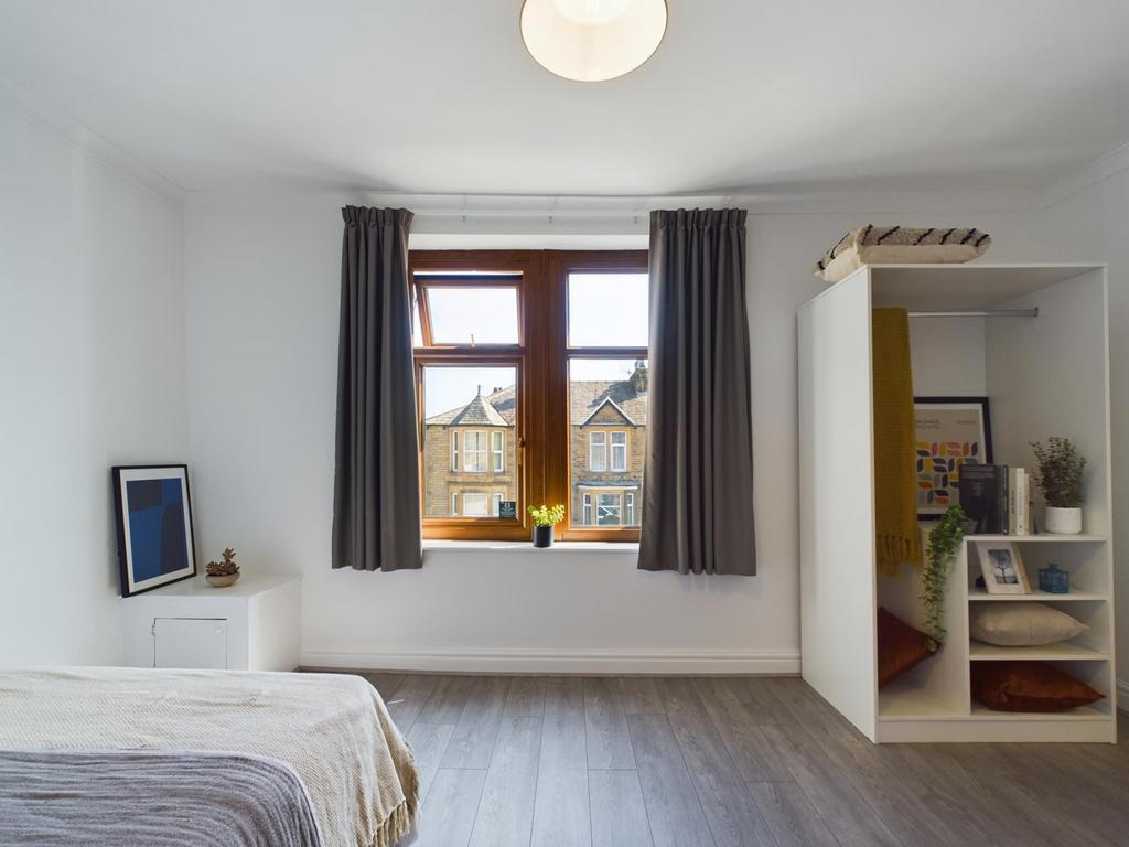A bright and inviting double bedroom featuring ...