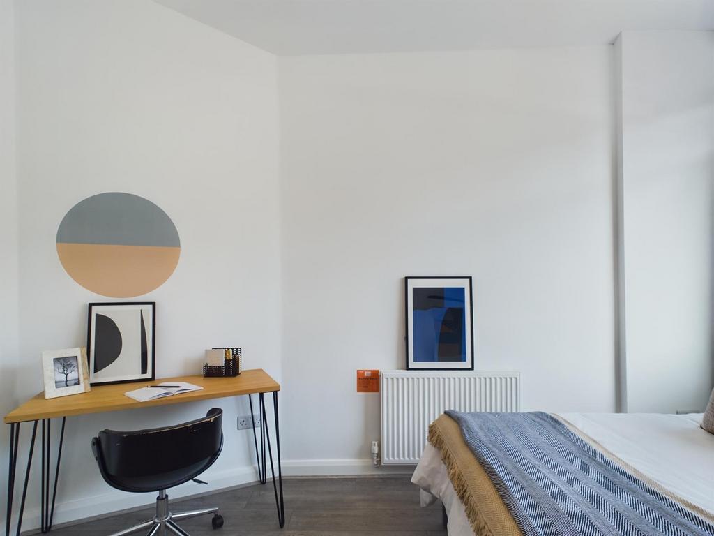 A stylish and well-lit double bedroom featuring...