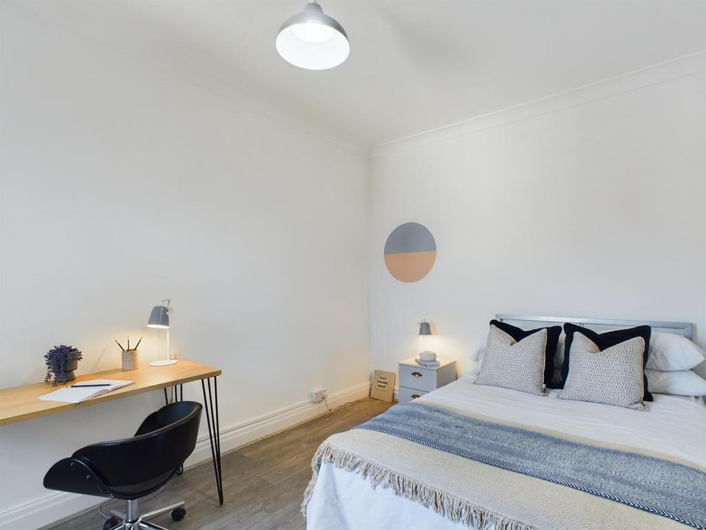 A bright and inviting double bedroom featuring ...