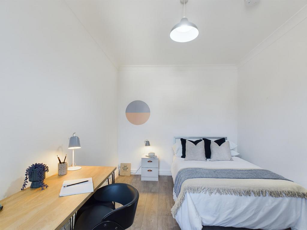 A bright and inviting double bedroom with moder...