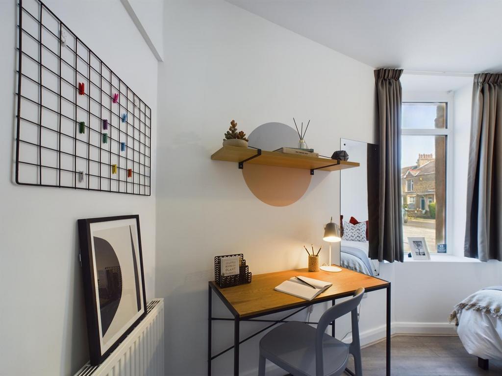 A bright and tidy double bedroom featuring a st...