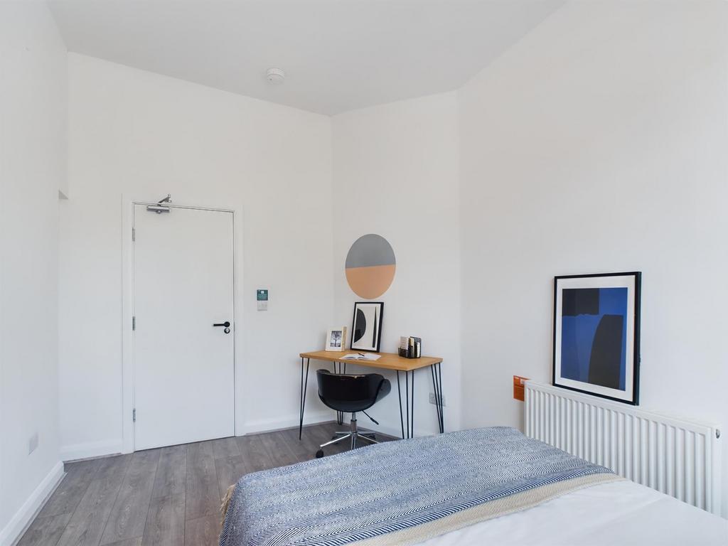 A bright and inviting double bedroom featuring ...