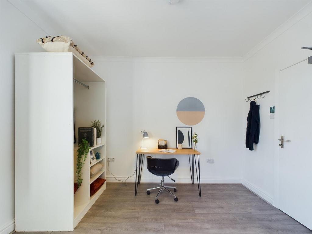A bright and tidy double bedroom featuring a st...