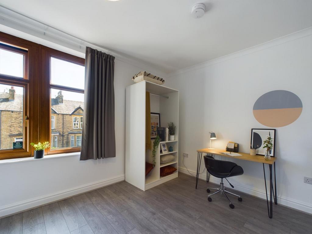 A bright and inviting double bedroom with ample...