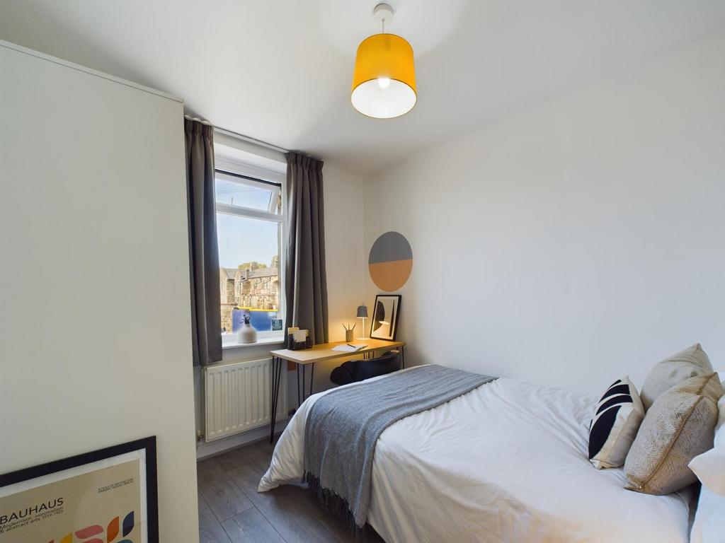 A bright and stylish double bedroom with modern...